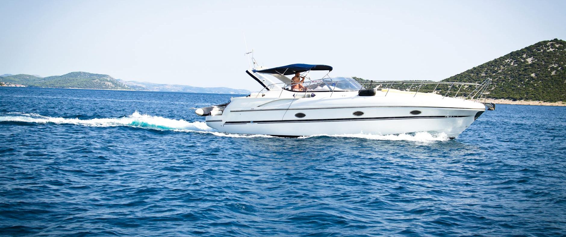 white speedboat on body of water