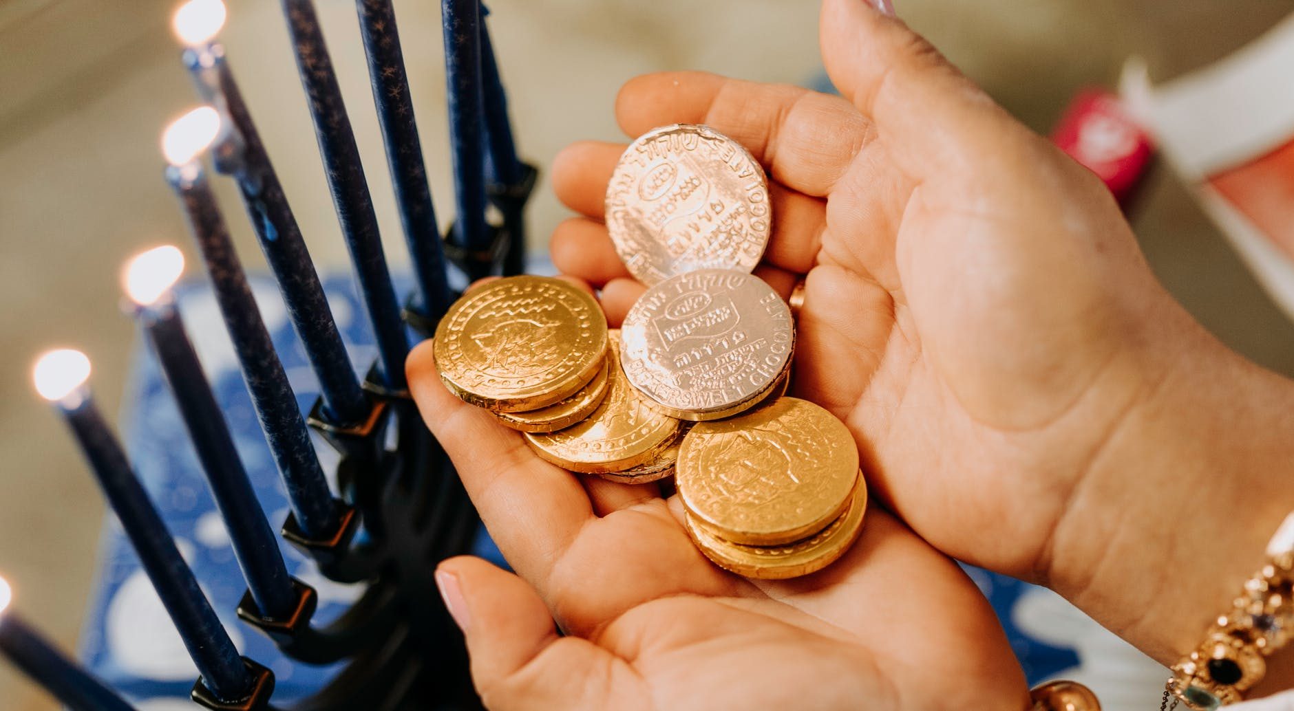 photo of person holding gold round coins