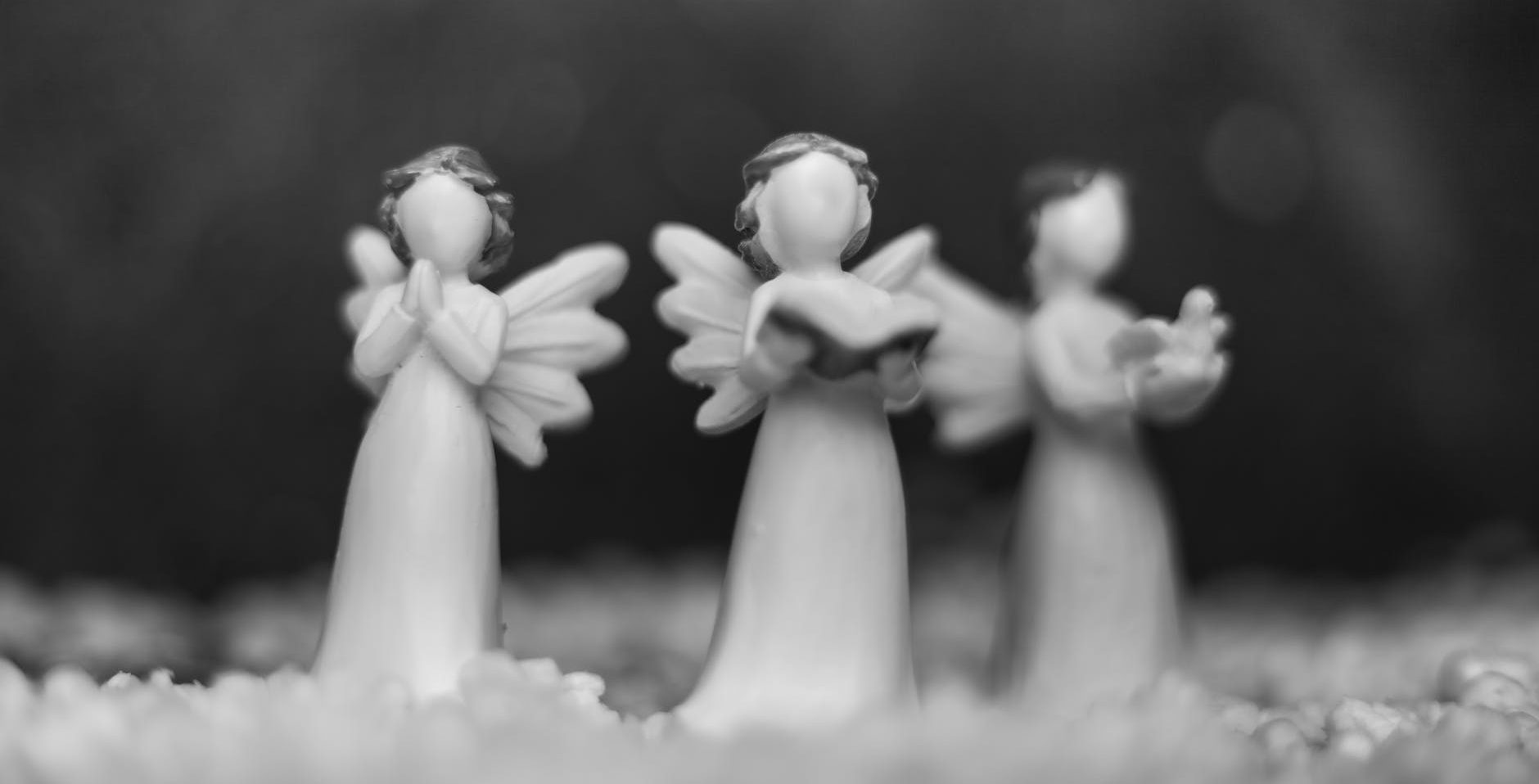 grayscale photo of angel figurines