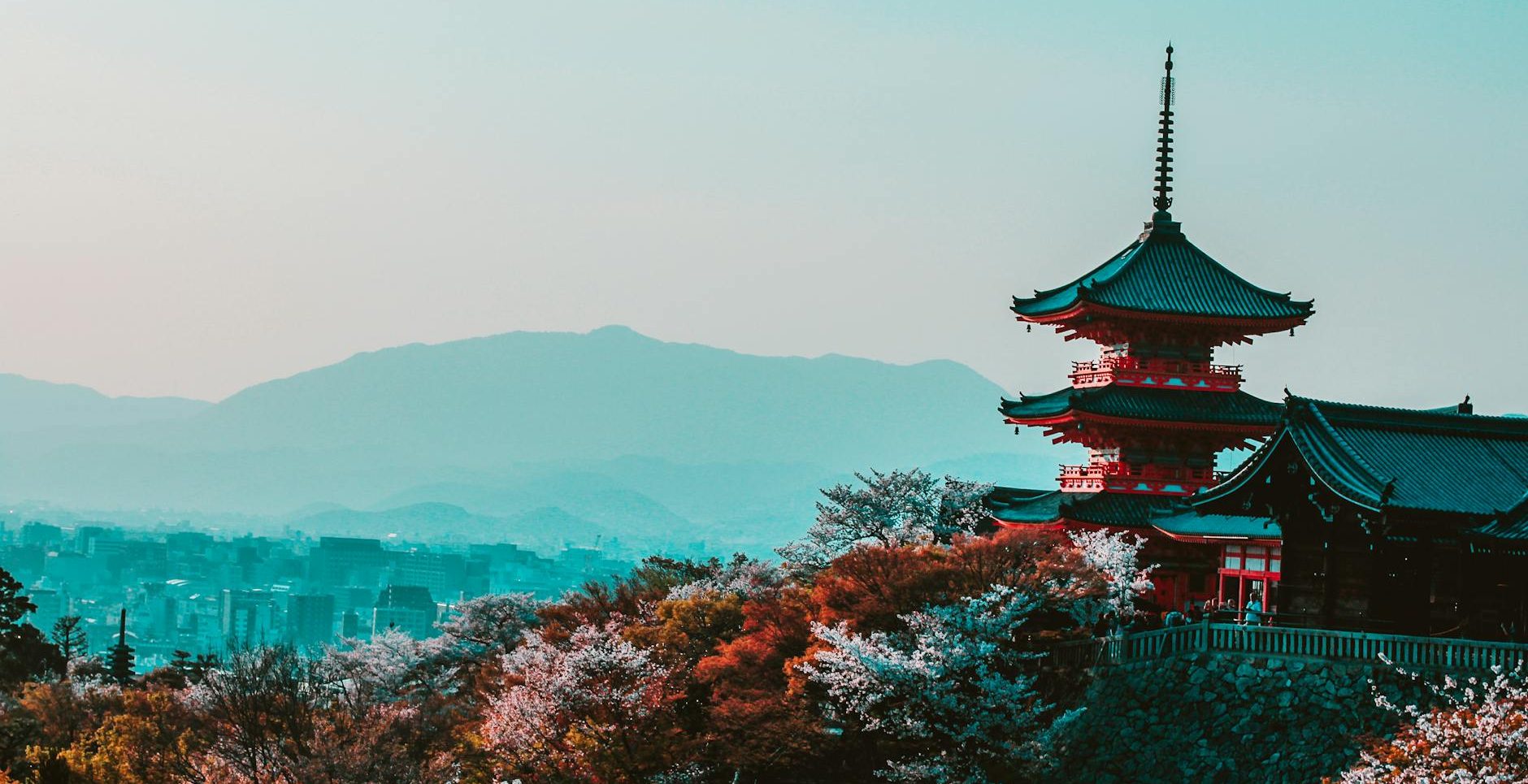 red and black temple surrounded by trees photo