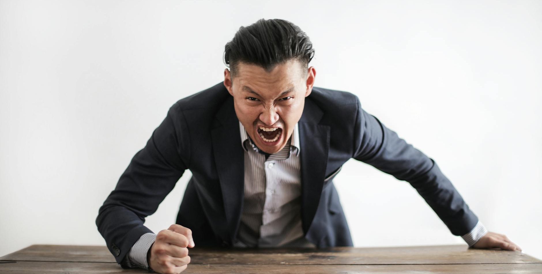 mad formal executive man yelling at camera