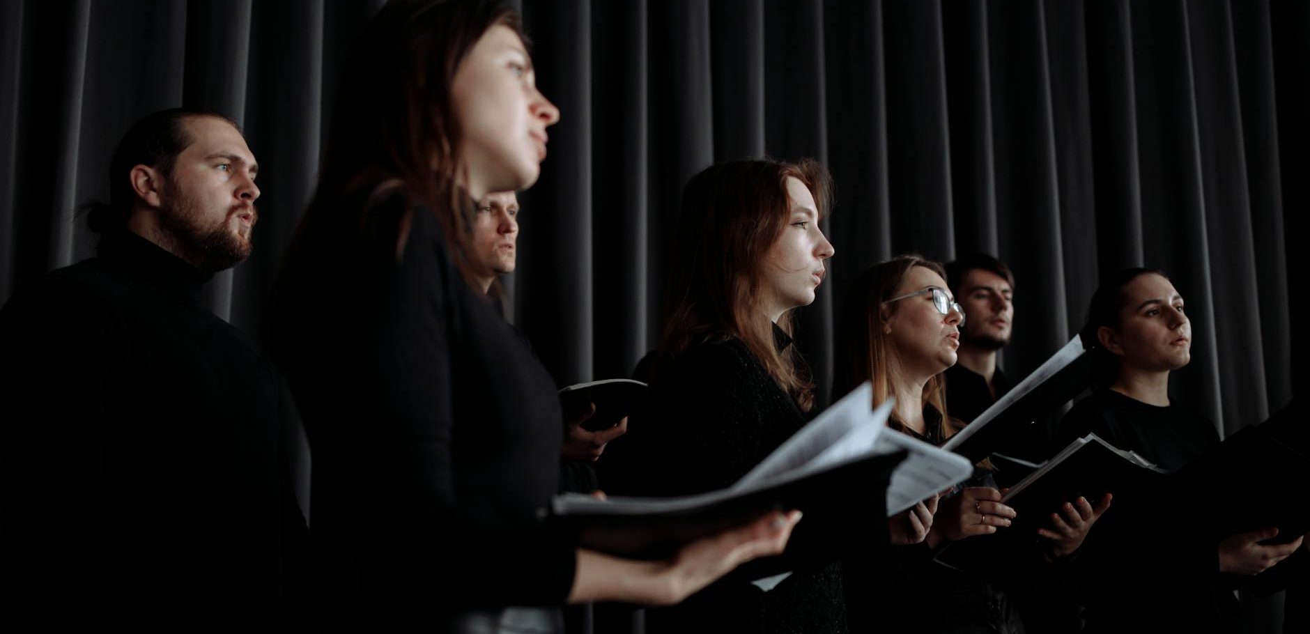 group of men and women singing together