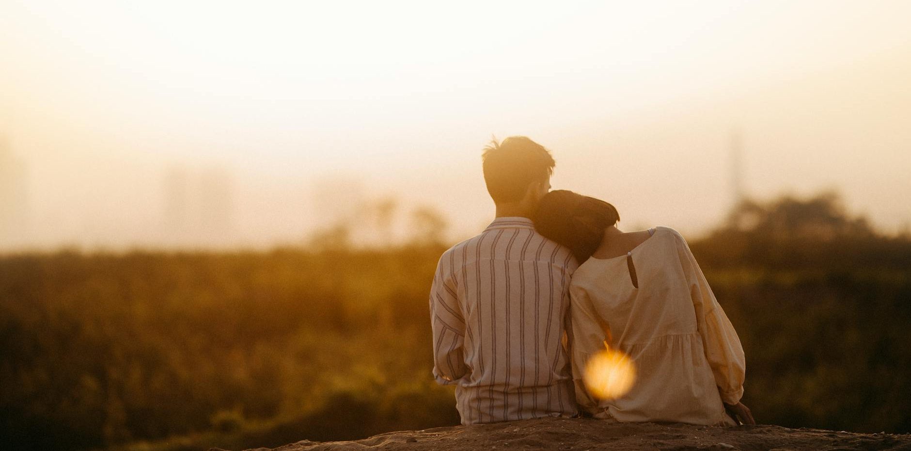 man and woman near grass field
